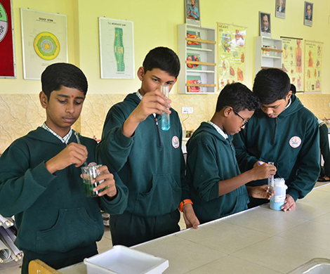 Students conducting experiments in the KVN College science laboratory