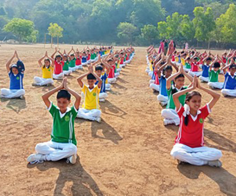 KVN College students practicing yoga in an outdoor session